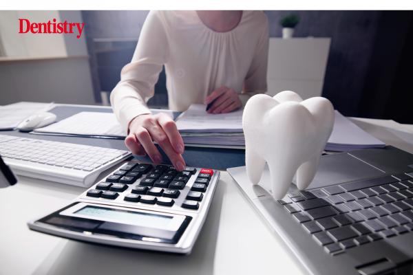 Dental professional at a desk committing NHS fraud